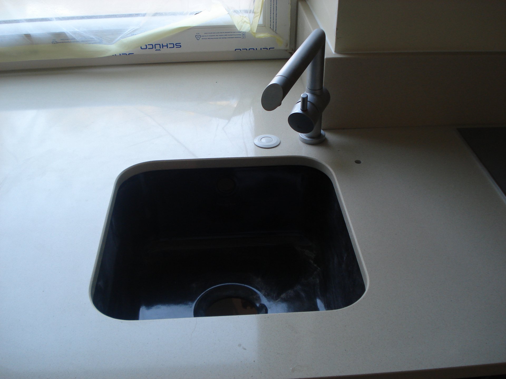 Biały granitowy blat kuchenny w nowoczesnej aranżacji z wyspą